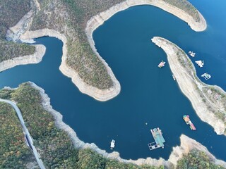 Wall Mural - Aerial view of a winding lake with floating docks.