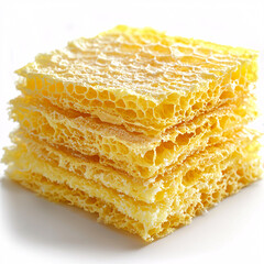 Sticker - Stack of yellow, porous, honeycomb-textured squares, light shining through the airy structure.