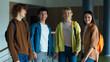 © Yuliia - High school Caucasian group teenagers pupils students university college males females men women girls boys guys classmates friends posing standing together indoors smiling at camera education study
