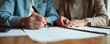 © sawaratch - Elderly couple's hands signing document at desk, power of attorney, paper