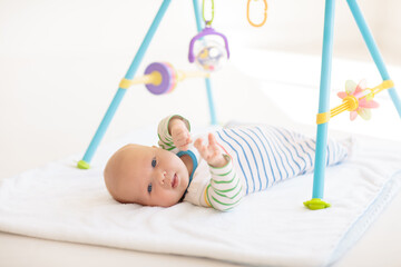 Wall Mural - Little baby on white bed