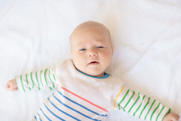 Wall Mural - Little baby on white bed