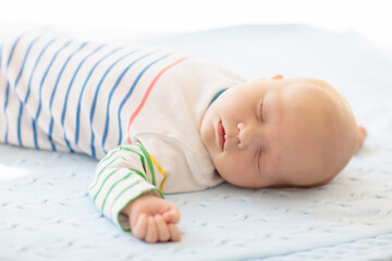 Wall Mural - Little baby on white bed