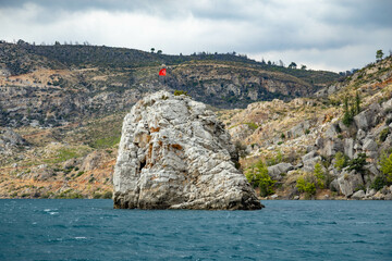 Rock with turkish flag in the middle of the water of  Green canyon . Manavgat River,  Antalya, Turkey. Popular tourist attraction.  