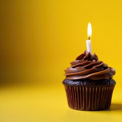 Wall Mural - Chocolate cupcake, lit candle, sunny yellow background, bright, colorful, cake