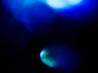Wall Mural - blue color light leaks on dark background for design and special effects.