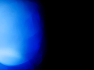 Wall Mural - blue color light leaks on dark background for design and special effects.