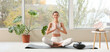 © Pixel-Shot - Young woman meditating near window at home