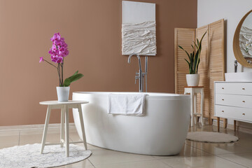 Wall Mural - Interior of bathroom with bathtub and orchid flower on table