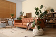 © Pixel-Shot - Monstera houseplant and cozy sofa in interior of living room