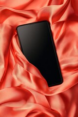 Poster - Smartphone with blank screen lying on red silk fabric, perfect for adding your content