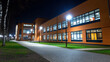 © Lerson - modern school building illuminated at night, showcasing its architecture and surrounding pathway