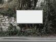 © Mnt - A blank billboard surrounded by greenery and natural elements.