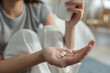 © Kawee - Close up hands of sick woman taking a medicine after wake up on bed.