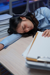 Sticker - Young businesswoman sleeping on her desk at night, overwhelmed by paperwork and deadlines, experiencing burnout and stress in a demanding corporate environment