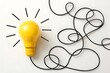 © Maksudul Islam Nahid - Yellow lightbulb idea concept with tangled cord creative inspiration mind goal power brain bright