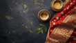 © Wasun - Traditional Indian saree with gold embroidery, bowls, and green leaves create rich cultural display. vibrant colors and textures evoke sense of celebration and heritage