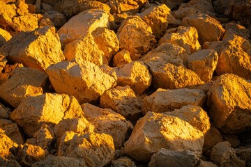 Poster - Pile of sunlit rocks against shadows, natural landscape, geology, texture, background