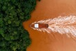 © Outkast - Boat sailing along a river from forest area. Aerial view. Stock photography