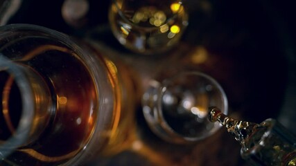 Fototapete - Super Slow Motion of Pouring Whiskey or Rum, Top View Shot. Filmed on High Speed Cinema Camera, 1000 fps. Low Depth of Focus.