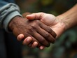 © Christianto - An inspiring close-up shot of multi-racial hands stacked on top of each other, symbolizing teamwork, diversity, and social inclusion, with a blurred background to focus on the hands