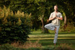 © peopleimages.com - Yoga, tree pose and portrait of man in garden for balance, wellness and peace for holistic fitness. Calm, yogi and mature person practice exercise, smile and healthy body with prayer hands in nature