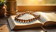 © Alla - Rosary beads on an open Koran in a warm light