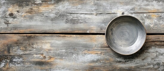 Aufkleber - Rustic wooden table surface with a vacant metallic plate positioned at the top right corner creating a serene, minimalistic composition.