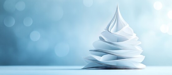 Poster - White paper Christmas tree decoration positioned on the right side of a softly blurred light blue backdrop with a festive holiday atmosphere