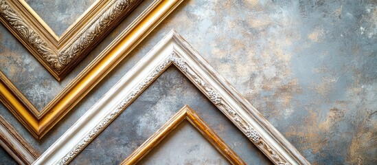 Fototapete - Elegant collection of ornate baguette picture frames in gold, silver, and white arranged diagonally on a textured gray background.