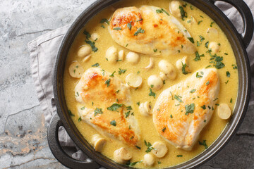 Wall Mural - Diane Chicken breasts sauteed with onions and mushrooms, then braised in herbs, spices and a brandy closeup in the skillet on the table. Horizontal top view from above