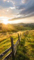 Wall Mural - A tranquil countryside scene with rolling green hills, a rustic wooden fence, and soft golden hour light creating a peaceful atmosphere