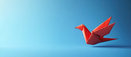 Aufkleber - Red origami crane positioned on the right side against a smooth blue gradient background, emphasizing creativity and elegance in design.