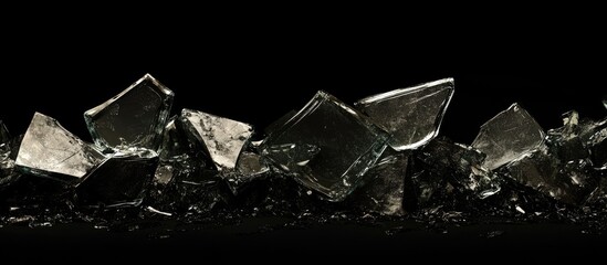 Leinwandbilder - Shattered glass fragments in varying sizes and angles on a dark background, showcasing reflective surfaces and sharp edges.