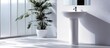 © meristock - Stylish white pedestal sink in contemporary bathroom with glass door shower area and large green plant creating a sleek modern aesthetic