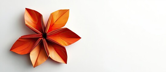 Leinwandbilder - Exotic orange origami flower with six petals positioned on the left of a clean white background, capturing elegance and craftsmanship.