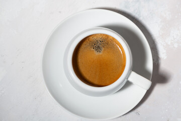 Wall Mural - black coffee in a cup on a white background, closeup