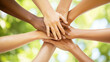 © littlepiccie - diverse group of hands stacked together in symbol of unity, teamwork and mutual support