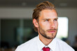 © Minerva Studio - Pensive businessman looking away wearing white shirt and red tie