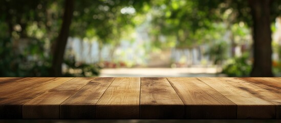 Canvas Print - Wooden tabletop with blurred nature background ideal for product display and promotional text space in a serene outdoor setting