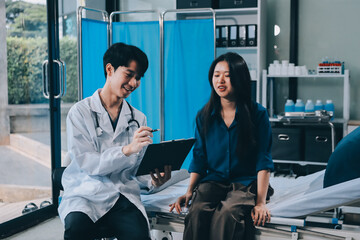 Wall Mural - doctor consulting senior old patient filling form at consultation. Professional physician wearing white coat talking to mature woman signing medical paper at appointment visit in clinic.