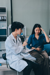 Wall Mural - doctor consulting senior old patient filling form at consultation. Professional physician wearing white coat talking to mature woman signing medical paper at appointment visit in clinic.