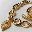 © Juan - Golden Leaf Charm Bracelet: A close-up shot of a luxurious gold chain bracelet adorned with an intricate leaf charm, showcasing the gleaming metal and delicate details.