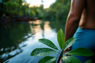 Canvas Print - Man paddling through lush mangrove river