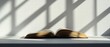 © fourtakig - Open Book on White Table with Natural Light and Shadow Patterns