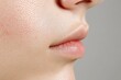 © Moopingz - Close-up of a woman's lower face, highlighting textured skin and natural lips.
