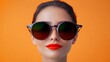 © Nataliia_Trushchenko - Woman with red lipstick and sunglasses. She is smiling and looking at the camera. The sunglasses are black and have a green tint