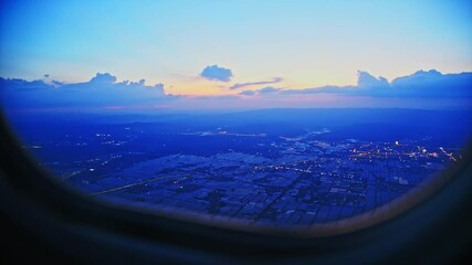 Wall Mural - aerial view of city through airplane window at night