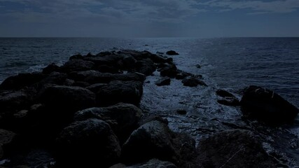 Wall Mural - waves crashing against the seashore at night