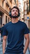 © Ilsol - A man wearing navy color t shirt mockup; with wireless headphones; on the street; front view